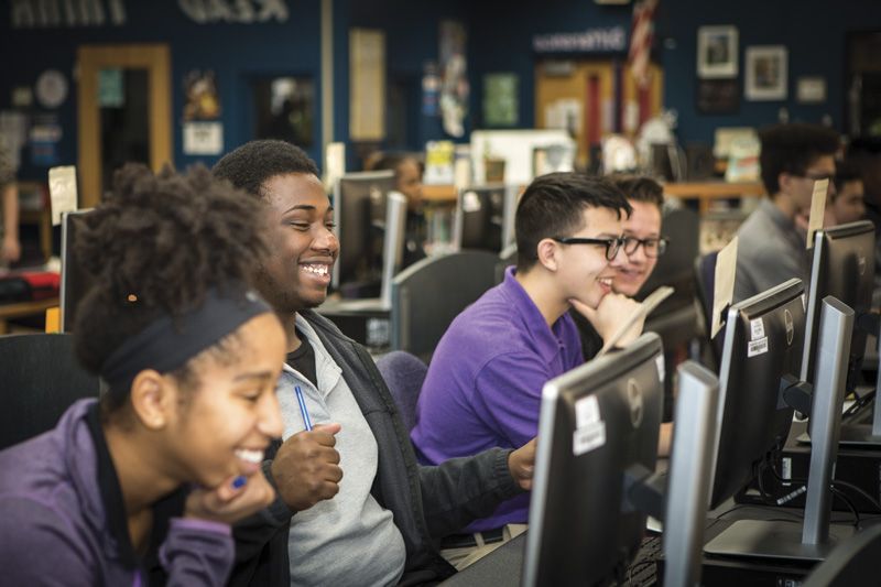 Smiling Tulsa Public Schools students in a computer lab.