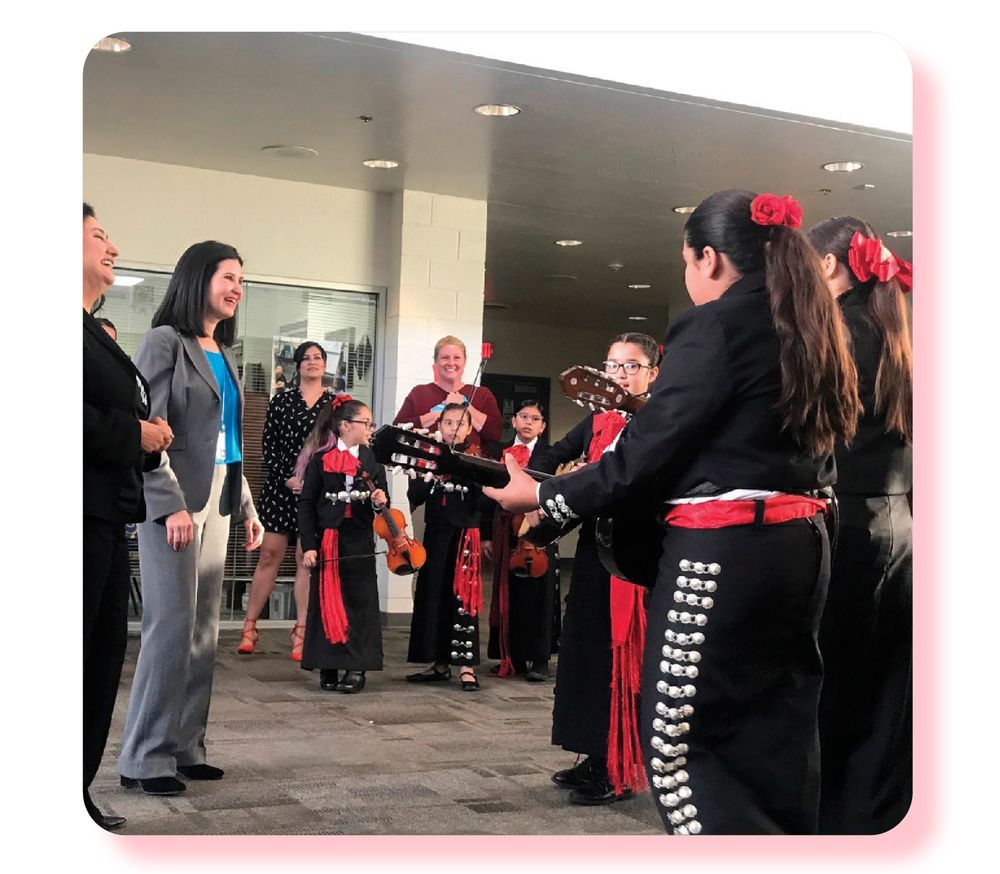 Dr. Hightower stands before a performing student Mariachi band.