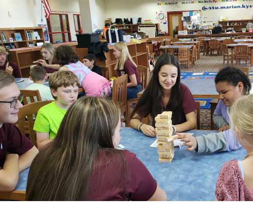 Student ambassadors play Jenga with younger students. 
