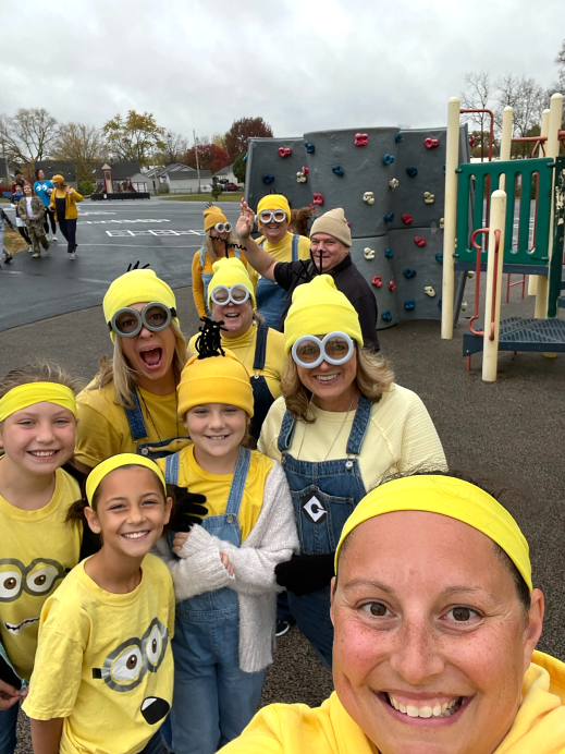 Photograph of Dr. Laura Blessing standing with staff and students all dressed as cartoon minions for Halloween 