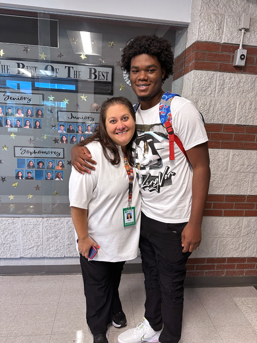 Photograph of Dr. Birhanzel standing with high school student