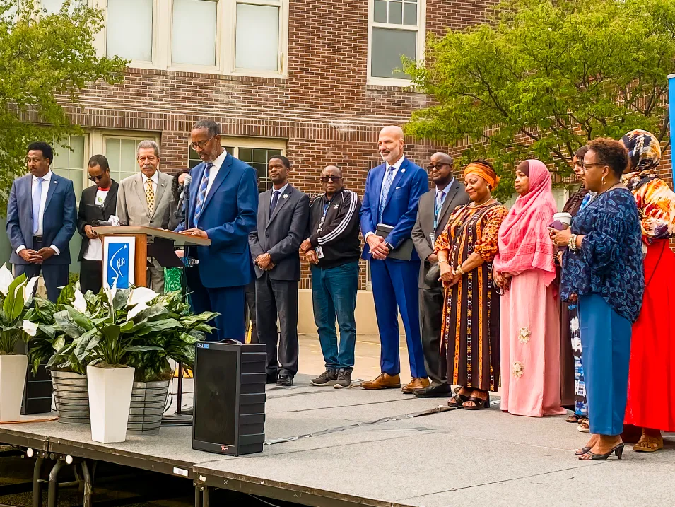 Photograph of Dr. Joe Gothard on stage with community members 